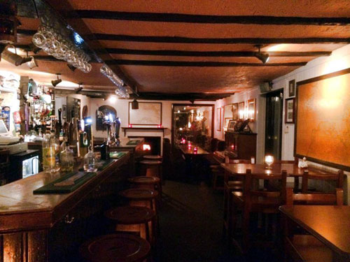 The inn has a traditional bar with timber seating and tables 