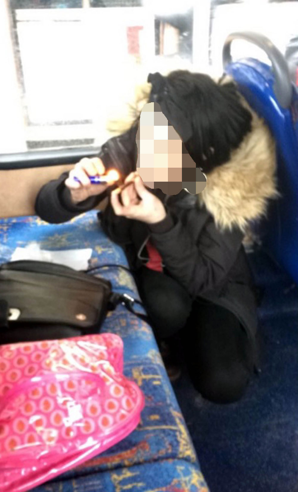 The woman appeared to smoke crack on a bus in broad daylight 