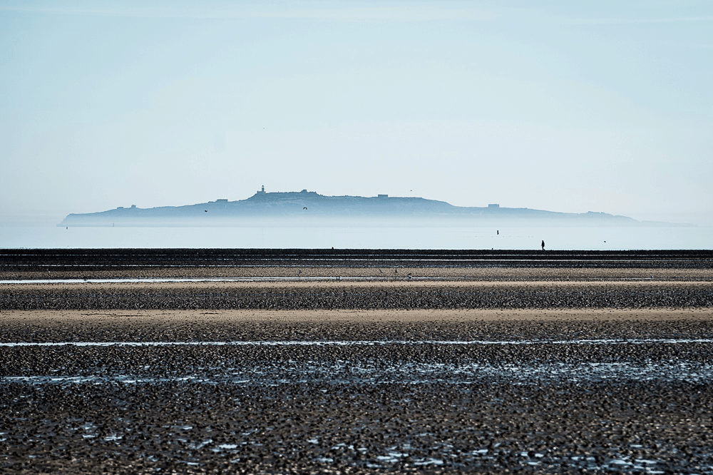 Nature: Inchkieth, an island in the Firth of Forth, rising through the early morning mist, viewed from Cramond beach.
