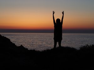 Holidaymaker at sunset on Greek island yoga retreat