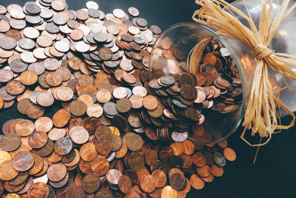 Pennies pour out of glass jar
