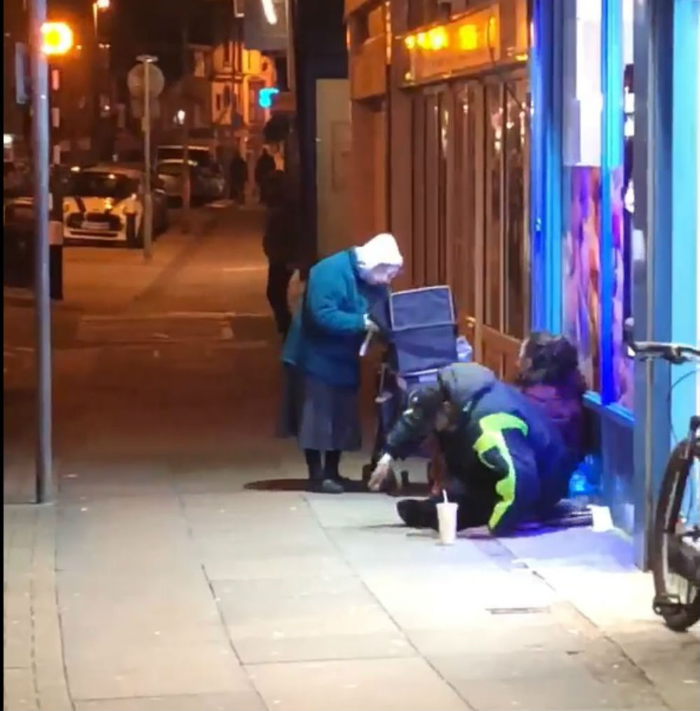Elderly woman handing out food to homeless on bitterly cold night praised as "absolute legend"