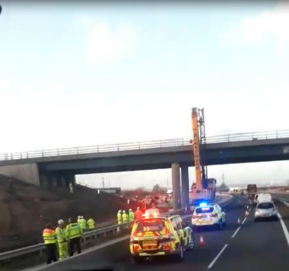 "How the f*** he done that?" Clip shows giant crane wedged under motorway bridge