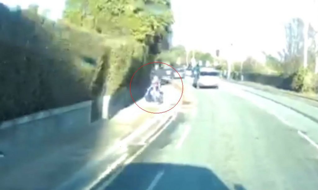 The young girl can be seen on her bike riding down the street before the near miss incident caught on a dashcam