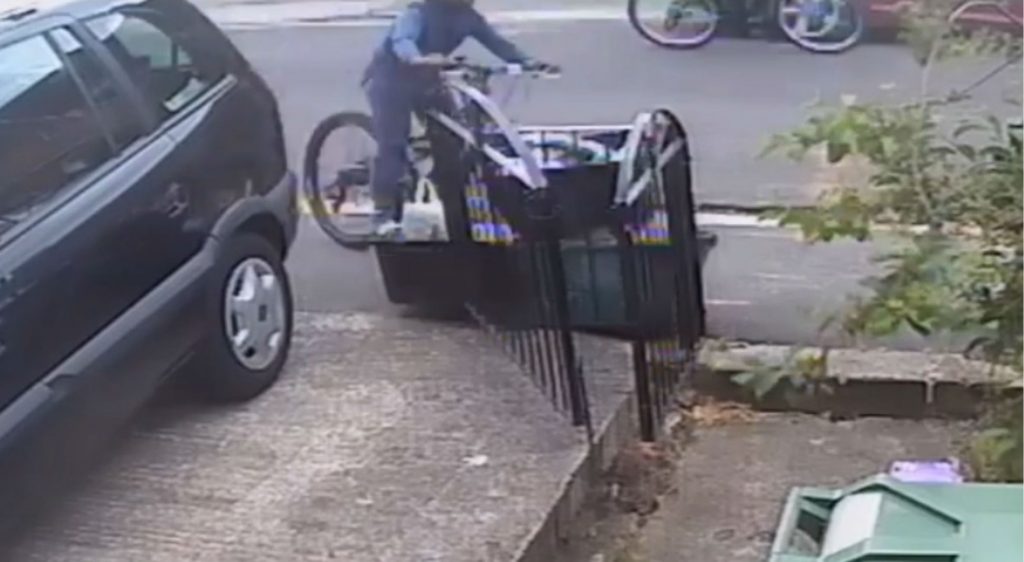 The cyclist going into the rubbish bin