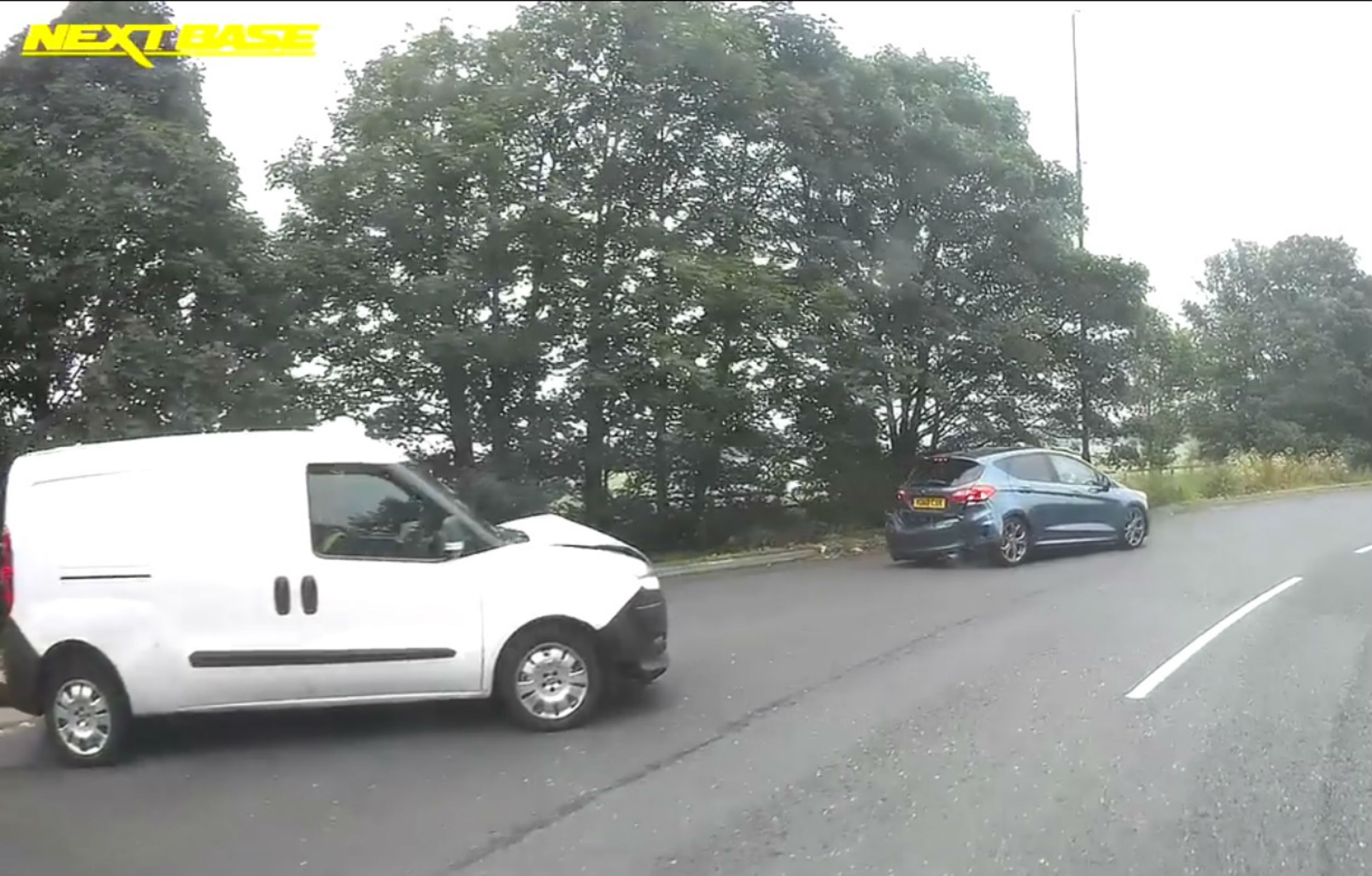 The two cars parked on the roundabout