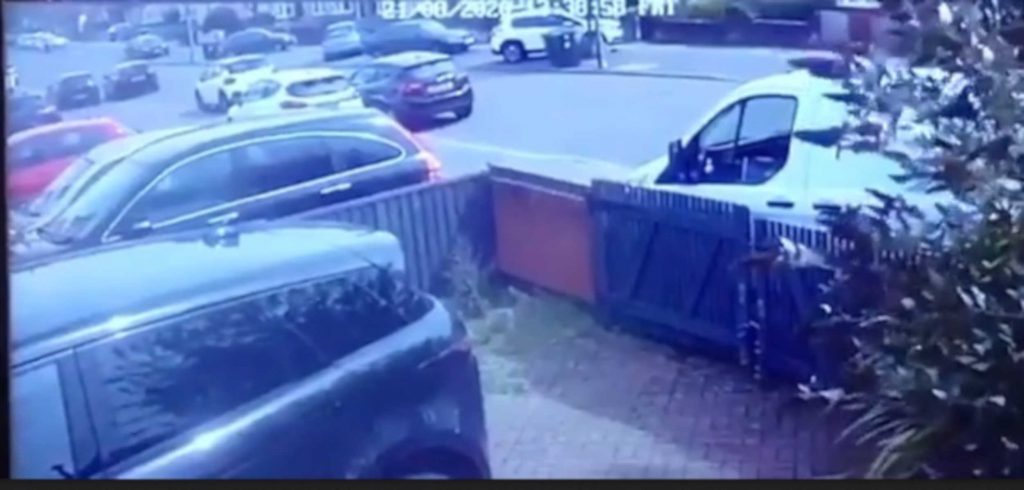 An Amazon driver was caught on CCTV chasing his van as it rolled down a hill before crashing into a wall