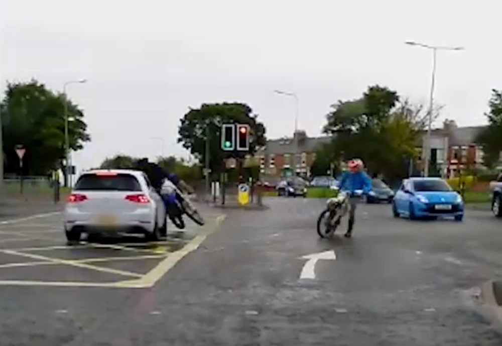 Shocking video captures an idiot biker hitting a car after running a red light