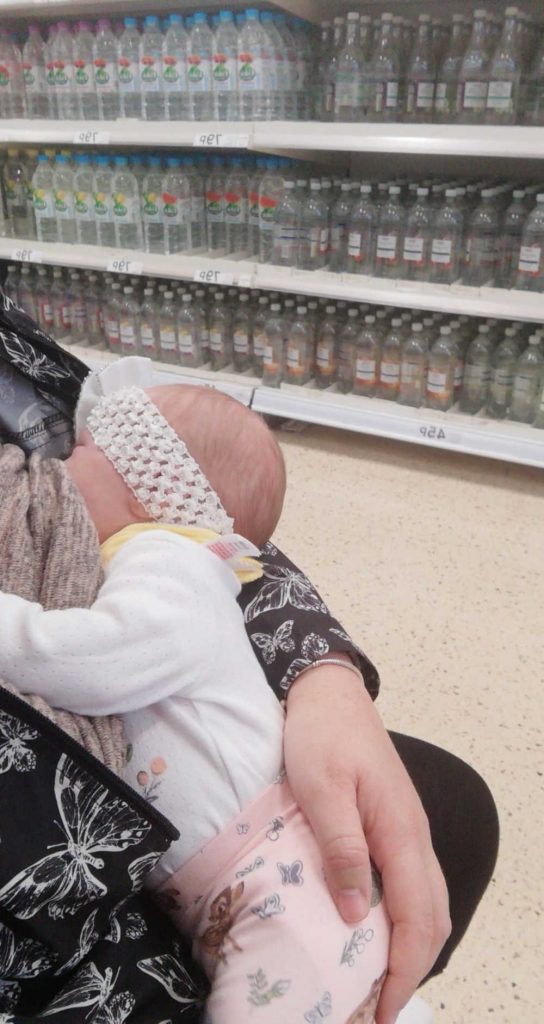 Mum breastfeeding her baby in an aisle in Tesco