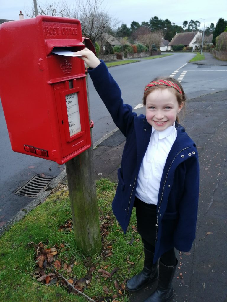 Murrin (Junior section) posting her card to Belhaven Care Home. Scottish News