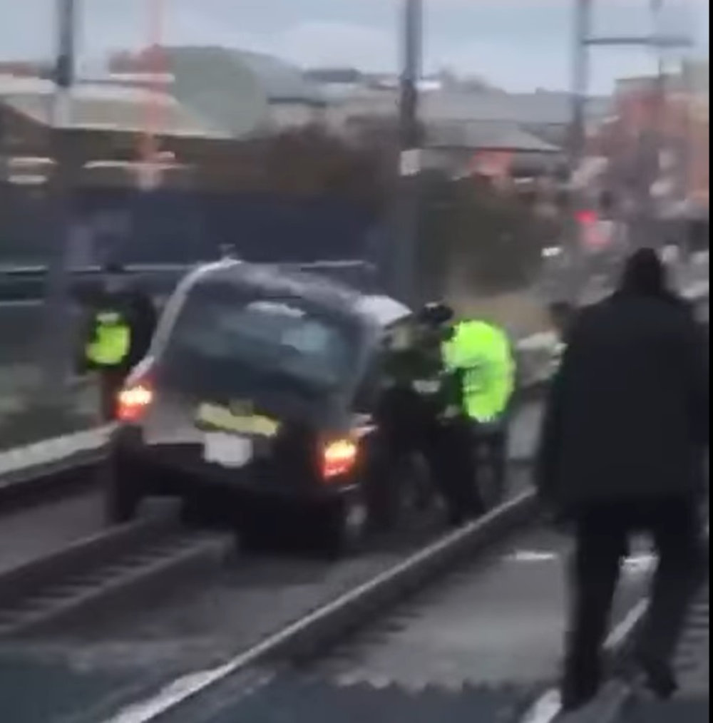 Taxi wedged between track  stops tram service _ Viral Niws UK