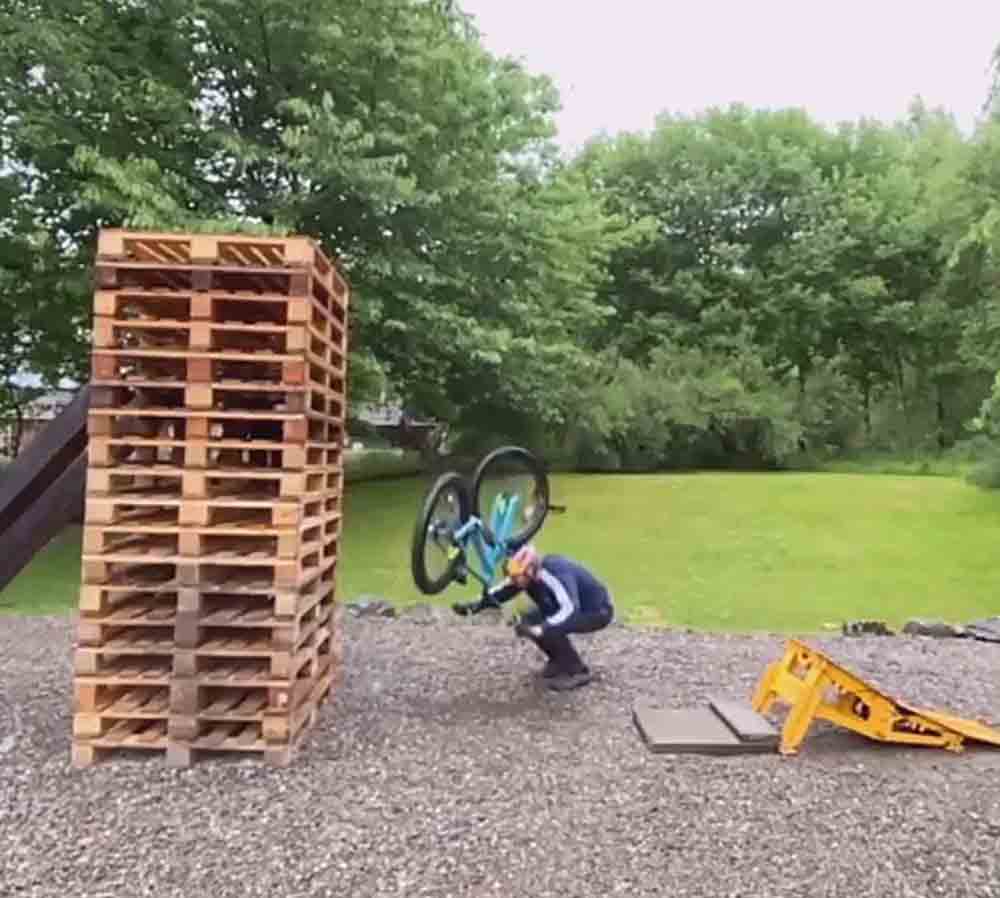Cyclicst Danny MacAskill jumps over huge stack of wooden pallets - Scottish News
