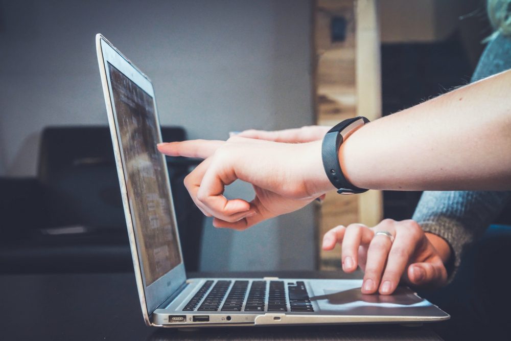 People pointing at a computer screen - business news Scotland