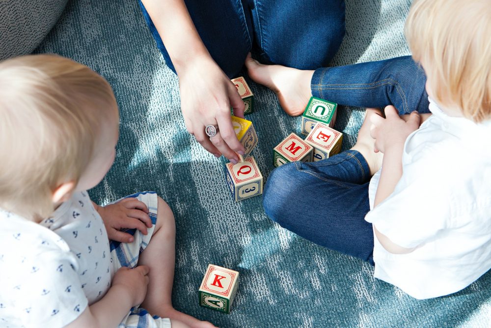 Children playing with letter blocks - Research News Scotland