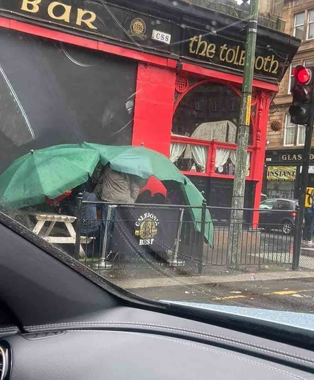 Hilarious Image Shows Hardy Scots Braving Rain To Drink Pints