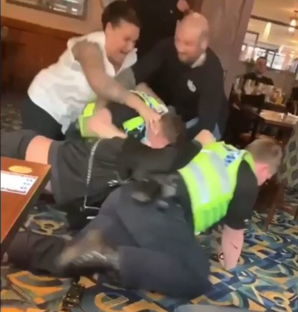 Two bystanders begin to pry off the assisting officer - Police News UK