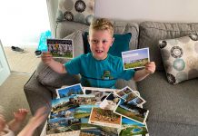 Little Ethan McCann with his postcards - UK News