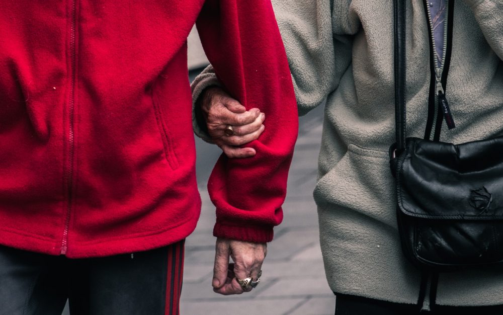 Two adults linking arms - Health News Scotland