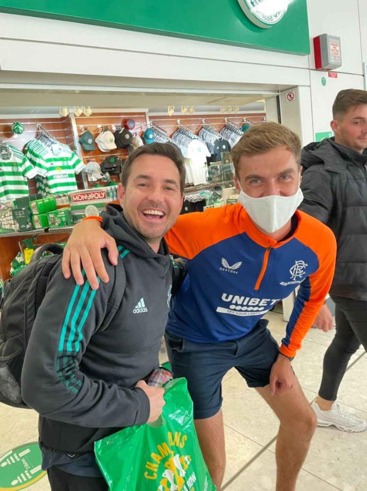Martin Compston poses with Rangers fan outside Glasgow Airport Celtic Shop
