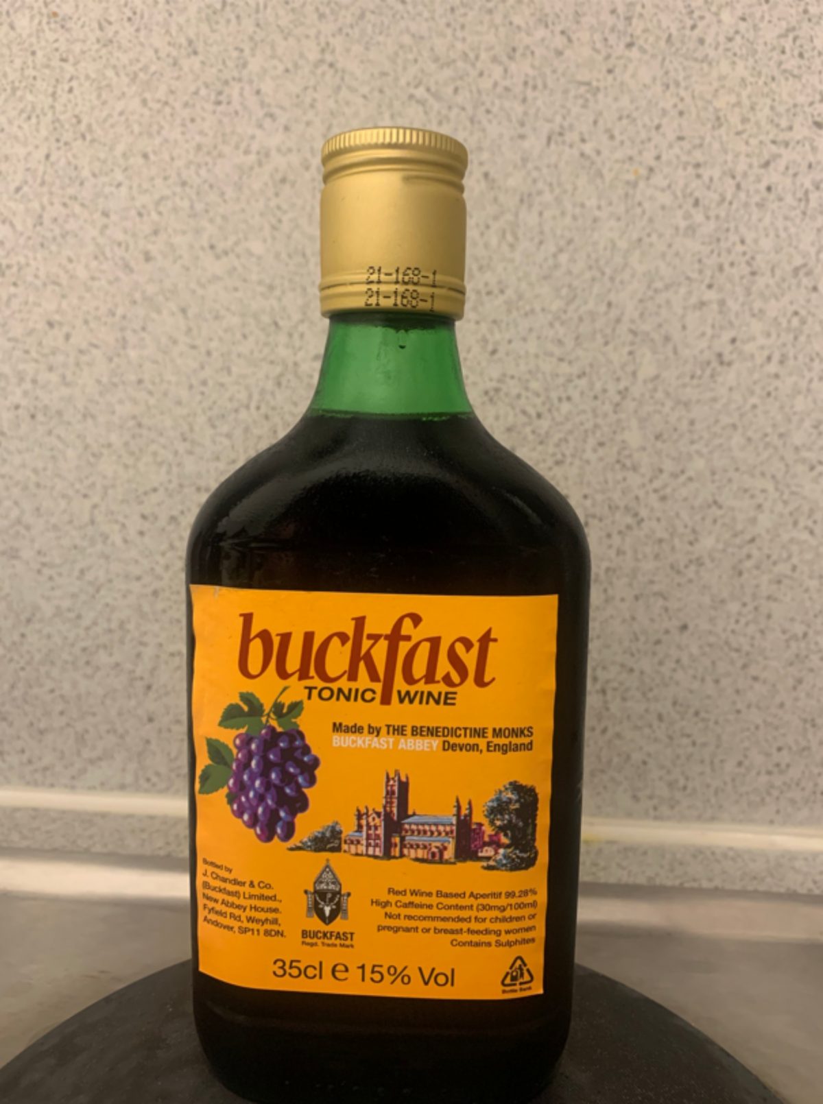 A bottle of Buckfast sits on a table