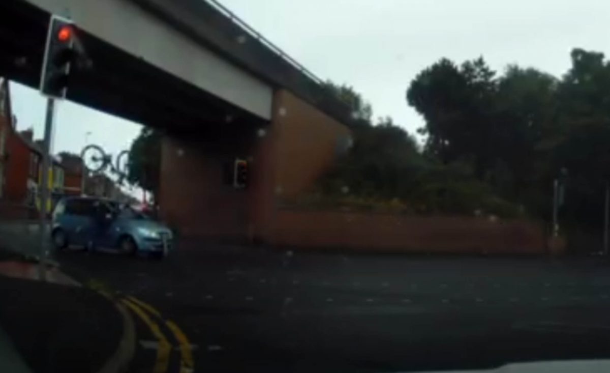 The cyclist crashing into the car and being catapulted over the bonnet.
