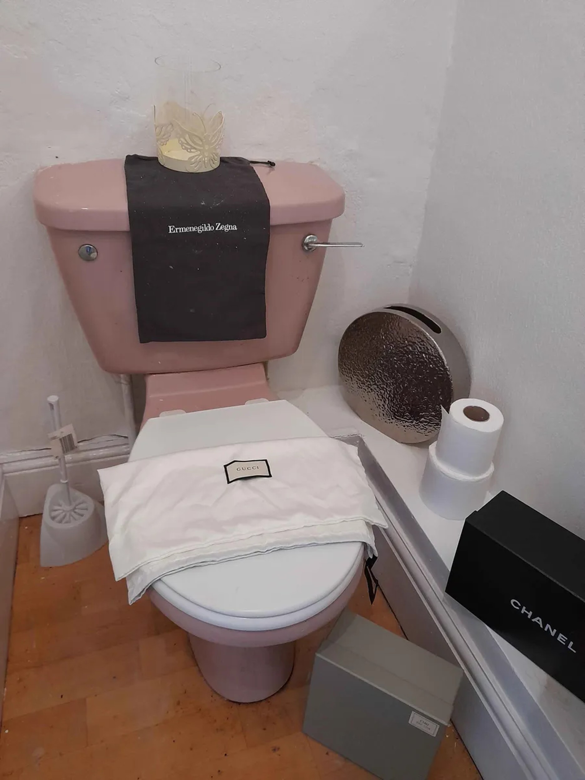 Various branded bags on the toilet