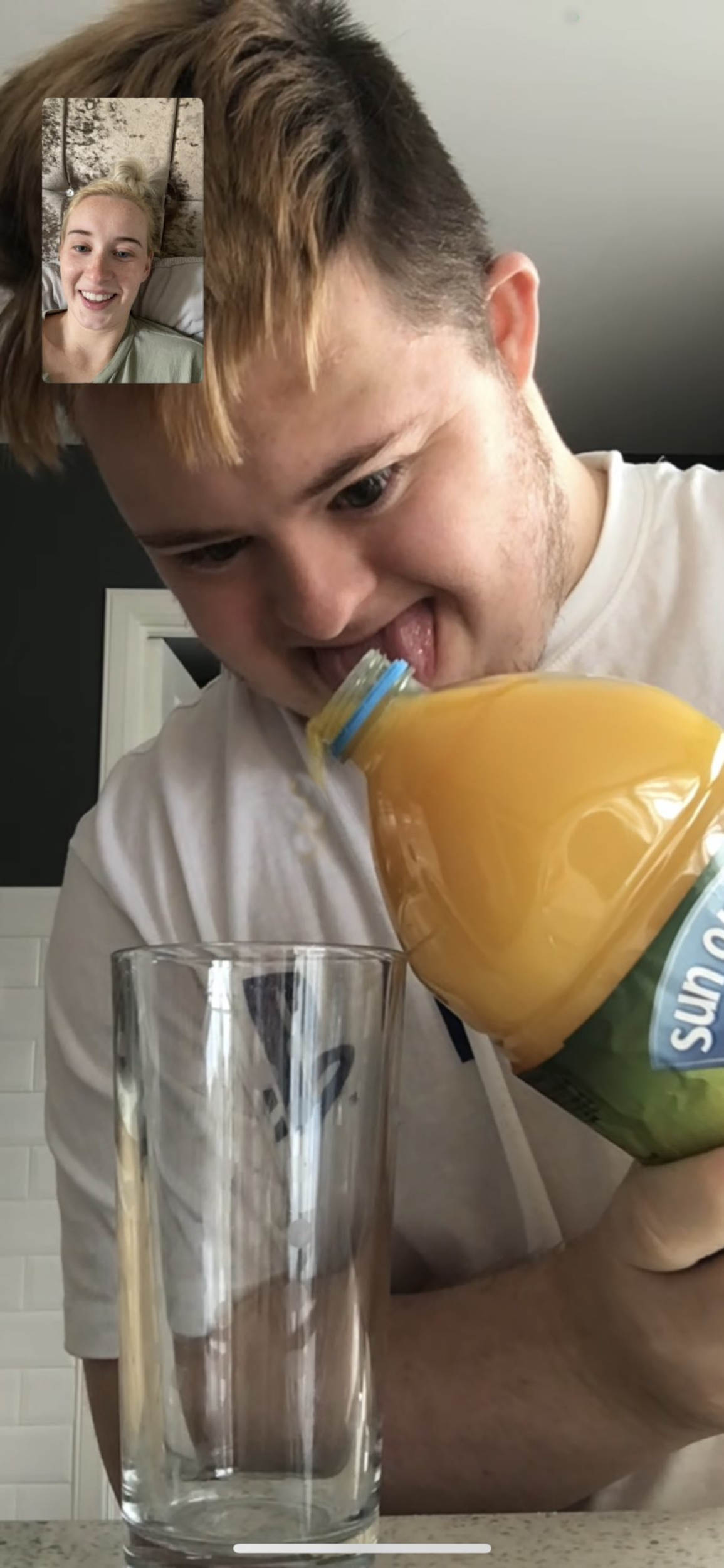 Michael McEwan making his twin sister's orange juice