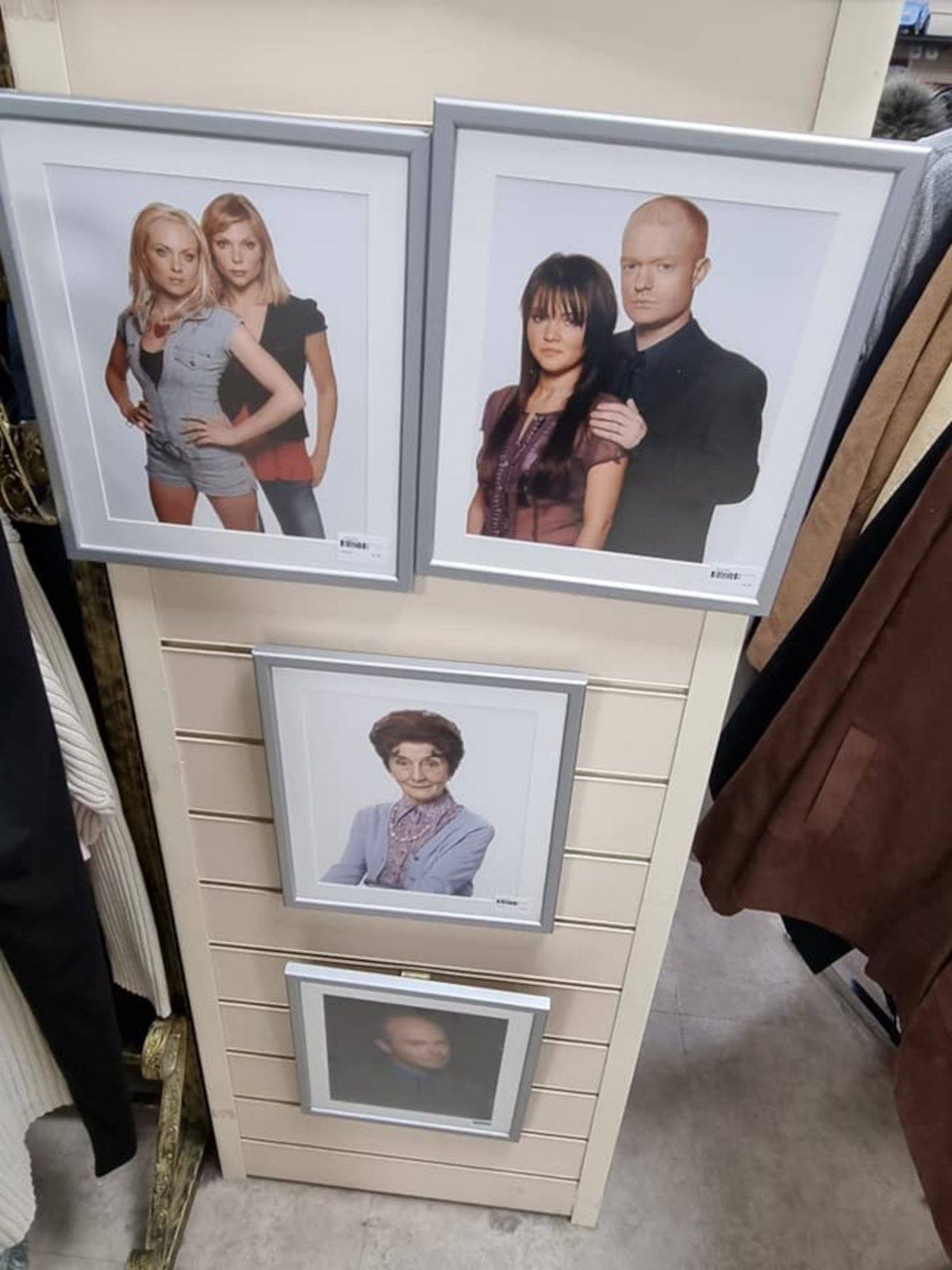 Eastenders character photos on the wall of the charity shop