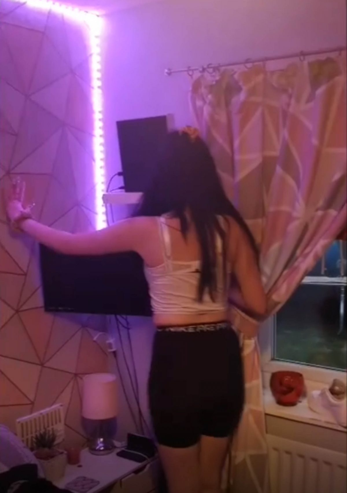 Kacey finding the key under her Xbox