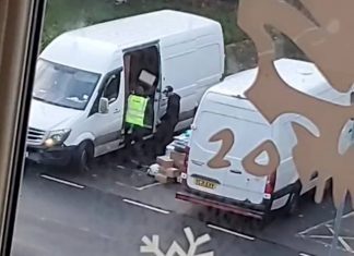 Courier workers throwing parcels into van