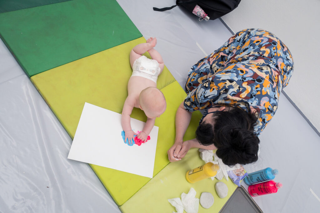 Woman and baby working with paint