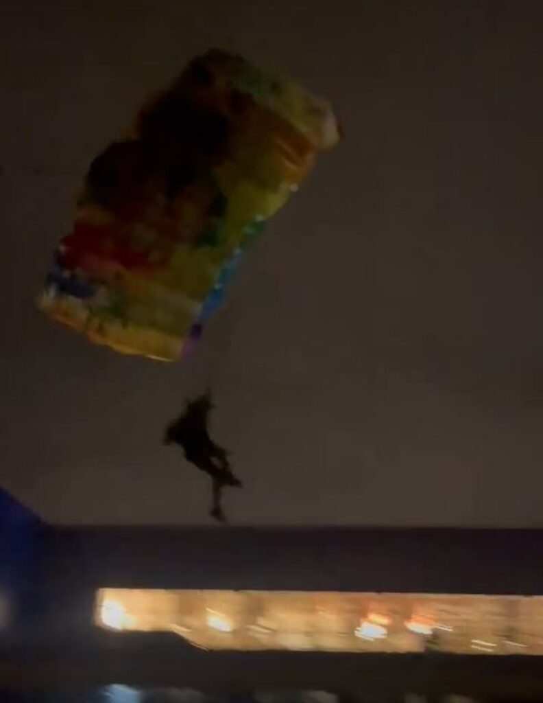 Daredevil parachutes off of chimney