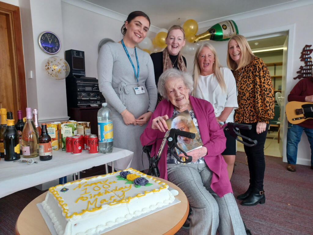 Mary Steele alongside staff from Dunedin Canmore's Royston Mains Close retirement home.