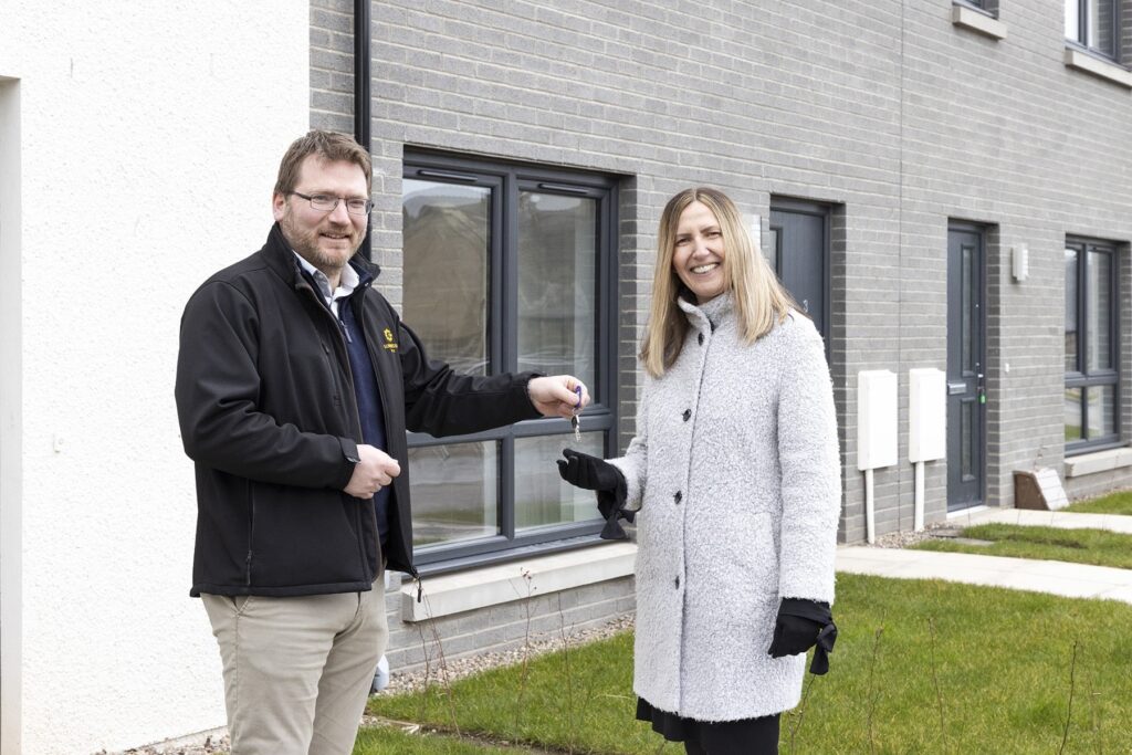 David Stewart, Director of Sunnyside Estate, hands over the keys of 12 new affordable homes to Fiona Morrison, Deputy Chief Executive, Hillcrest Homes.