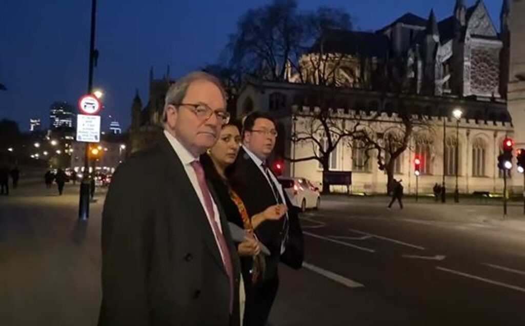 The MP's stood waiting for taxis near at Westminster