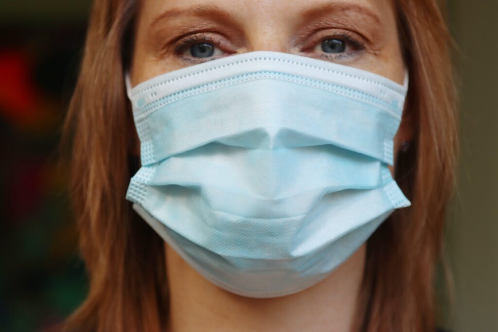A woman wearing a disposable mask