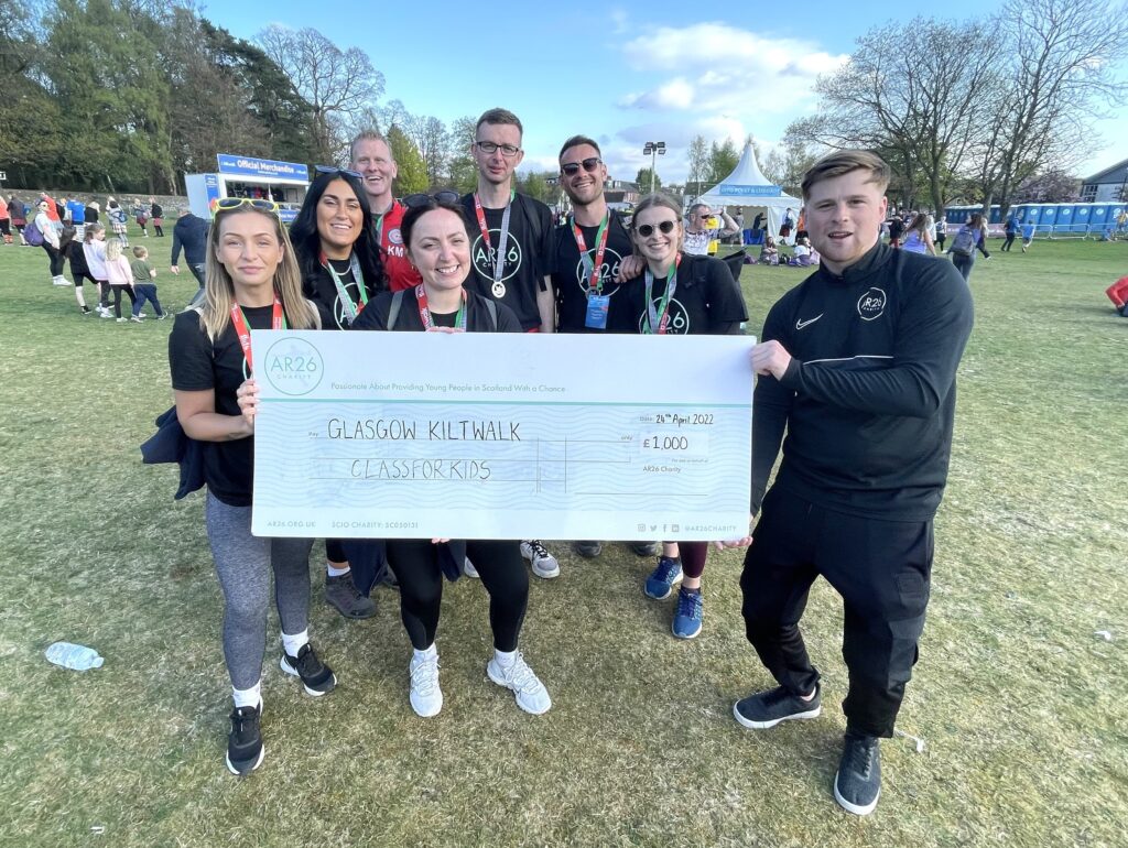 The ClassForKids team with the £1,000 they raised for AR26 at the Glasgow Kiltwalk in April.