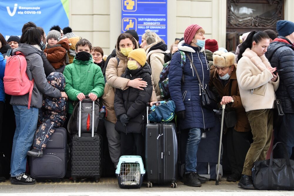 Ukrainian refugees waiting with luggage
