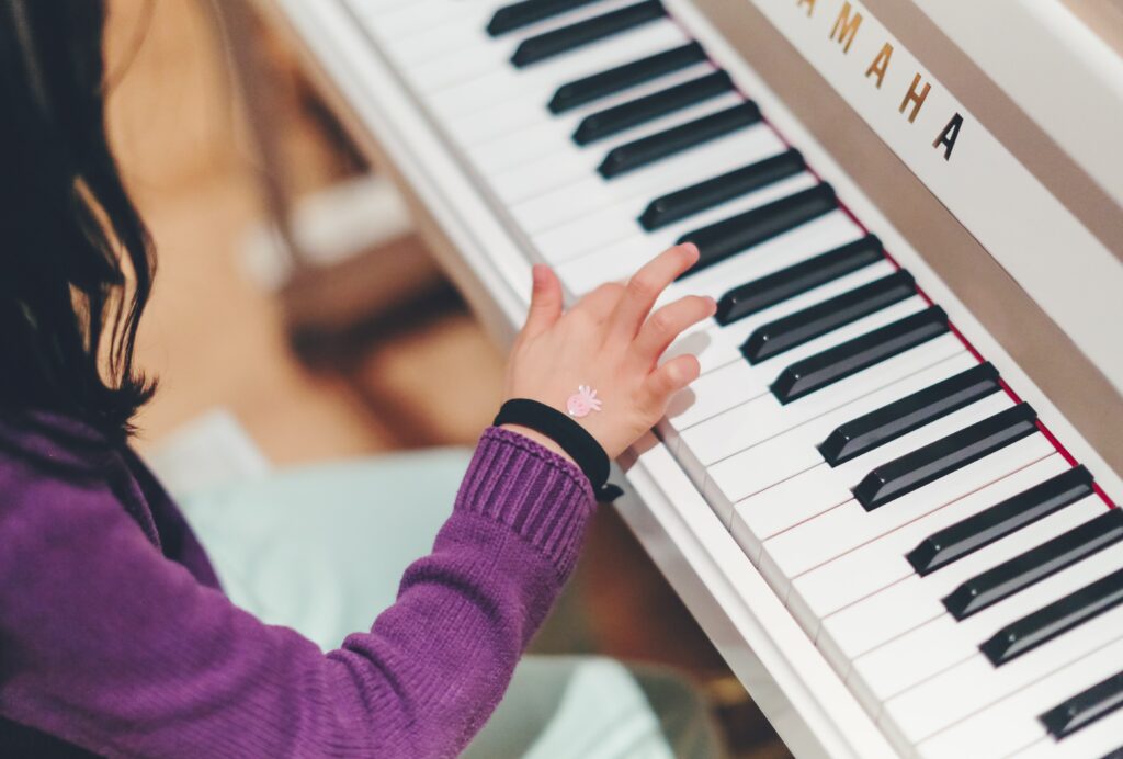 Young girl playing keyboard.