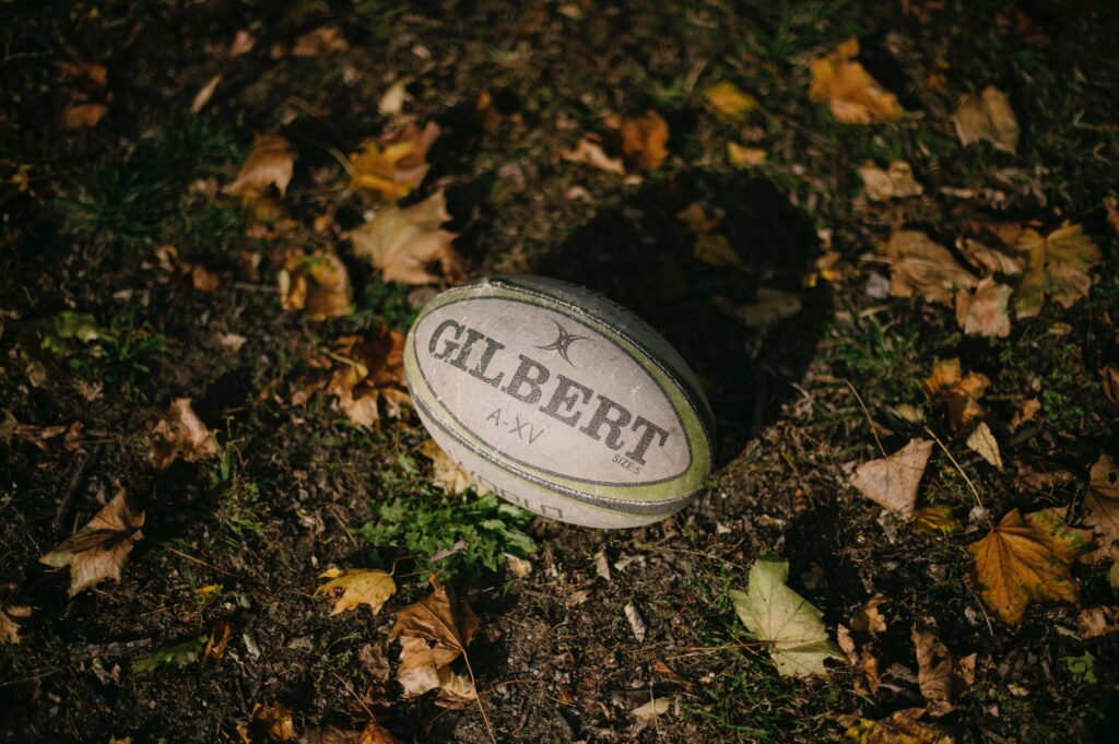 Gilbert rugby ball laying on the ground.
