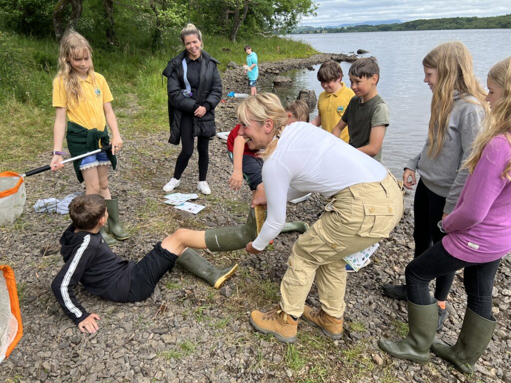 A ranger helping out youngsters at Loch Ken.