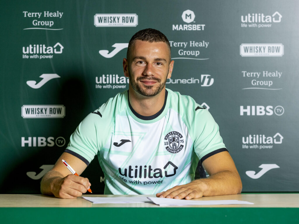Marijan Cabraja pictured signing a Hibs contract.