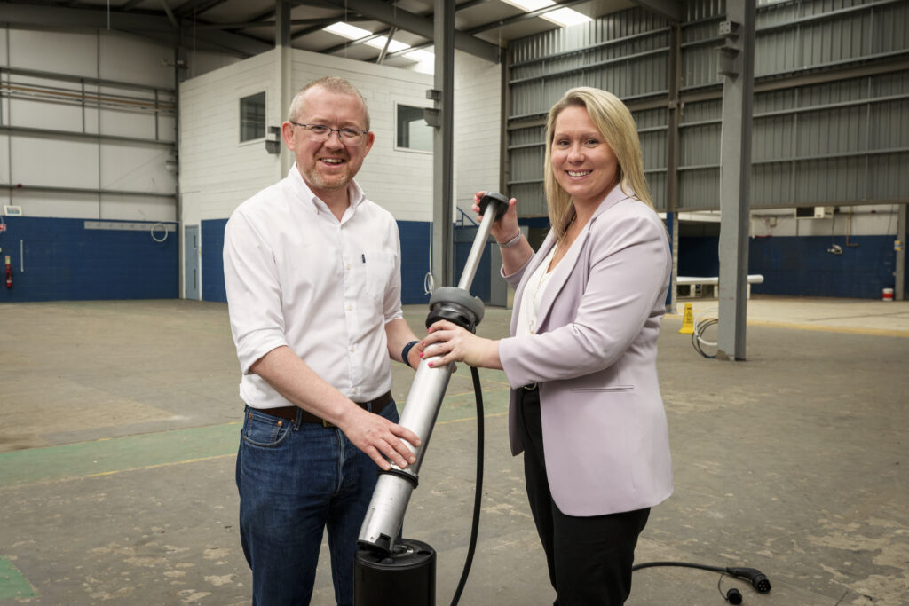 Ian Mackenzie (L) and Nicola Douglas (R) pictured with one of Trojan Energy's flat-and-flush charging points.