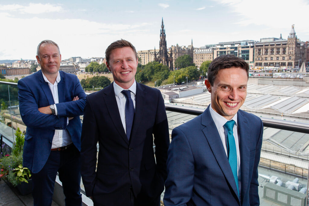 Anderson Strathern's newly appointed partners, Gary Burton and Robbie Wilson, join Chair Bruce Farquhar for a photo overlooking Edinburgh Waverley.