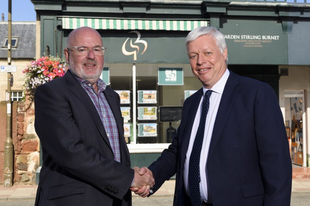 Tony O'Malley (L) of Friends Legal shakes hands with Alan Borrowman (R) from GSB.