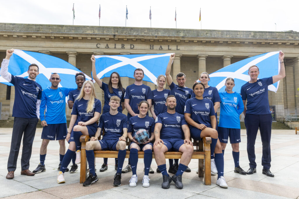 Street Soccer Scotland members posing in front of Caird Hall in Dundee.