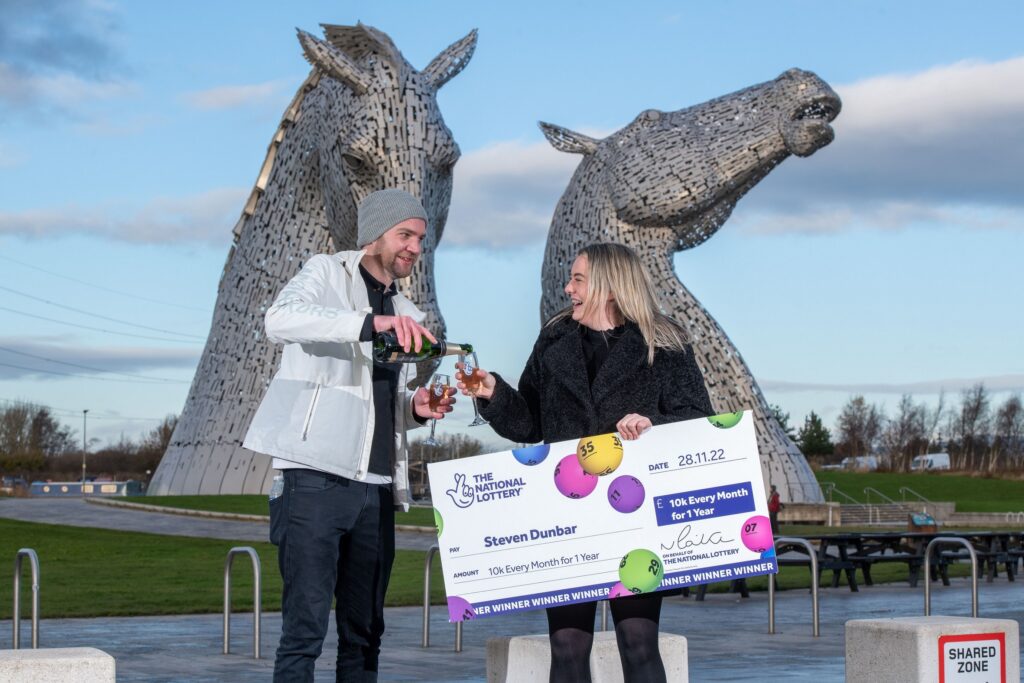 Steven Dunbar and partner Rebecca celebrating in front of the Kelpies in Falkirk.