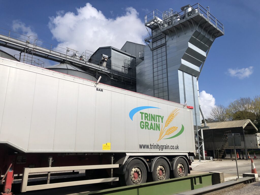 Trinity Grain lorry in front of a silo.