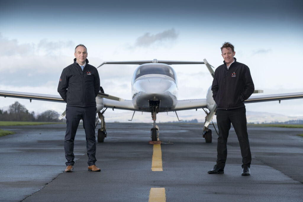 ACS MD Graeme Frater (L) and Director Craig McDonald (R) pictured in front of an aircraft on a runway.