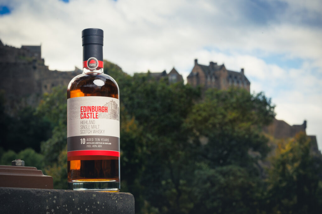 Edinburgh Castle whisky bottle with the castle in the background.